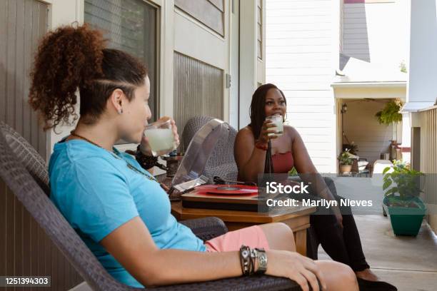 Loving Lesbian Couple At Home Enjoying Music Stock Photo - Download Image Now - African Ethnicity, African-American Ethnicity, Porch