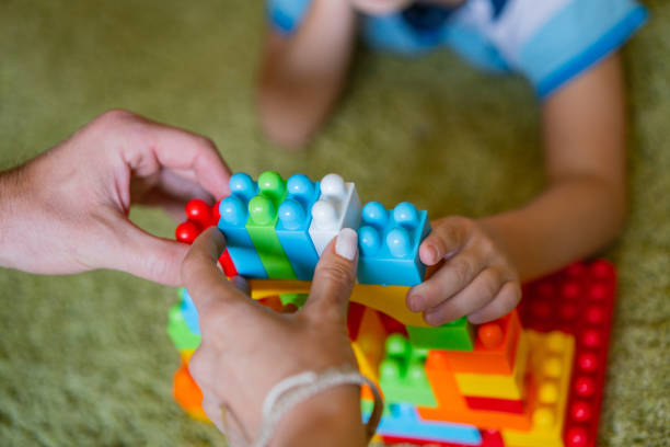 istock Boy with parents plays with toys in home quarantine 1251405560