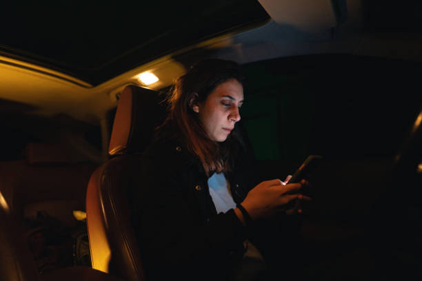 istock Upset young woman text messaging in her car 1251407700