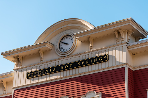 Hot Springs, Va historic downtown town city in Virginia countryside with closeup of sign clock time on building