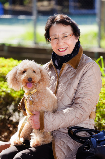 A happy Japanese senior citizen woman sitting in a park with her pet dog.\n\n[url=search/lightbox/9532452] [img]http://richlegg.com/istock/banners/japan_banner.jpg[/img][/url]\n[b][url=search/lightbox/9532452]Click HERE to see more Japanese images[/url][/b]\n\n[url=search/lightbox/3907913] [img]http://richlegg.com/istock/banners/senior_banner.jpg[/img][/url]\n[b][url=search/lightbox/3907913]Click here to see more Active Senior images[/url][/b]\n\n[url=search/lightbox/11370194] [img]http://richlegg.com/istock/banners/dog_banner.jpg[/img][/url]\n[b][url=search/lightbox/11370194]Click HERE to see my other Doggie images[/url][/b]