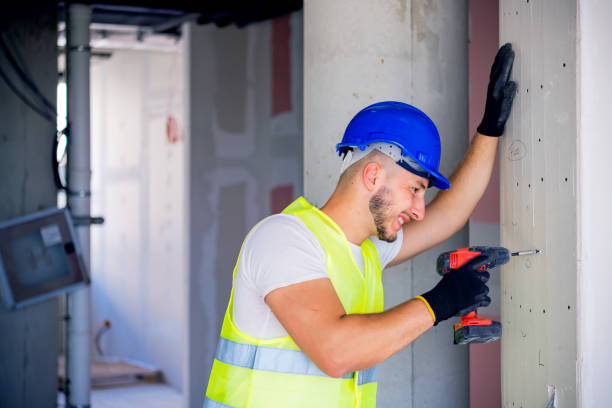 istock Construction Worker With Cordless Drill Drilling Wall In Renovated House 1251409000