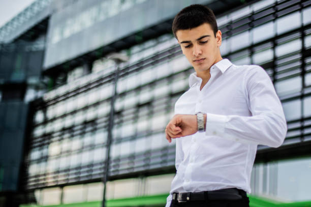 istock Young businessman checking the time on  watch 1251409103