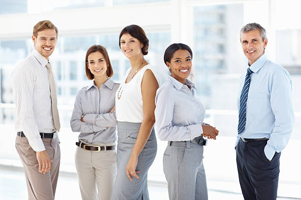 istock Mature business woman smiling with co-workers 125141054