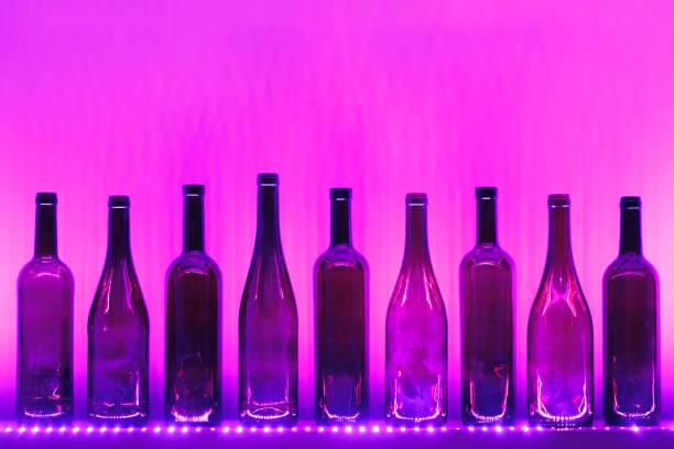 abstract empty wine bottles with purple led illumination
