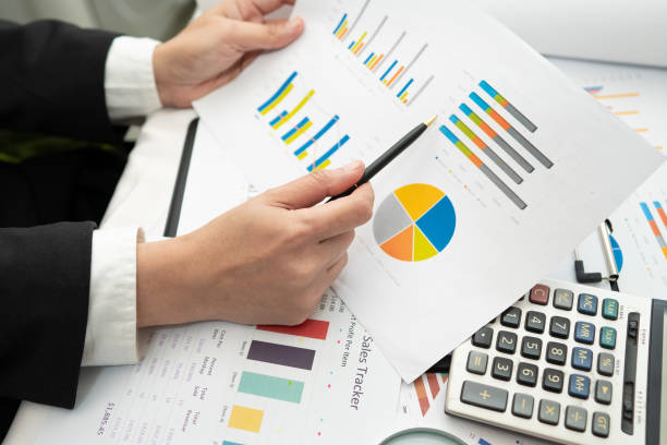 istock Asian accountant working and analyzing financial reports project accounting with chart graph and calculator in modern office,finance and business concept. 1251414295