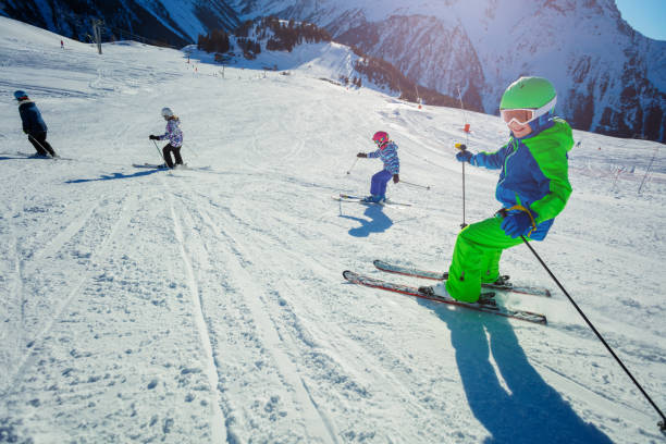 istock Ski school for kids skiing down in mountains 1251415489