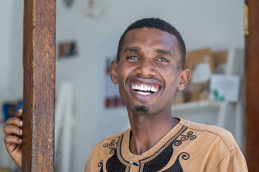 Zanzibar, Tanzania - november 23, 2019 : African joyful man with a big smile at a local street food market on the island of Zanzibar, Tanzania, east Africa, close up