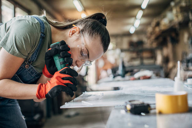 istock Woman manual worker working in workshop 1251418522