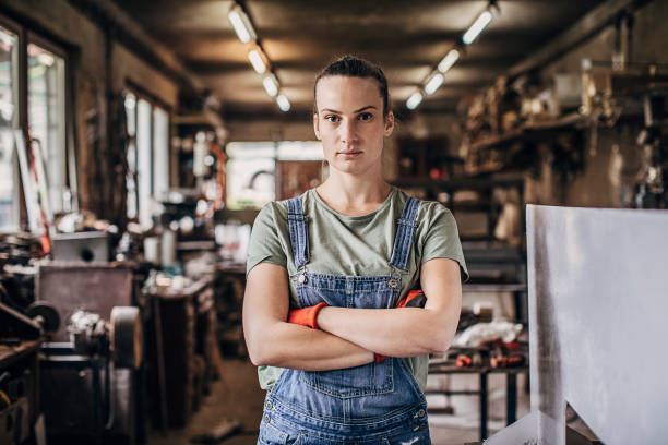 istock Young woman manual worker standing in workshop 1251419050