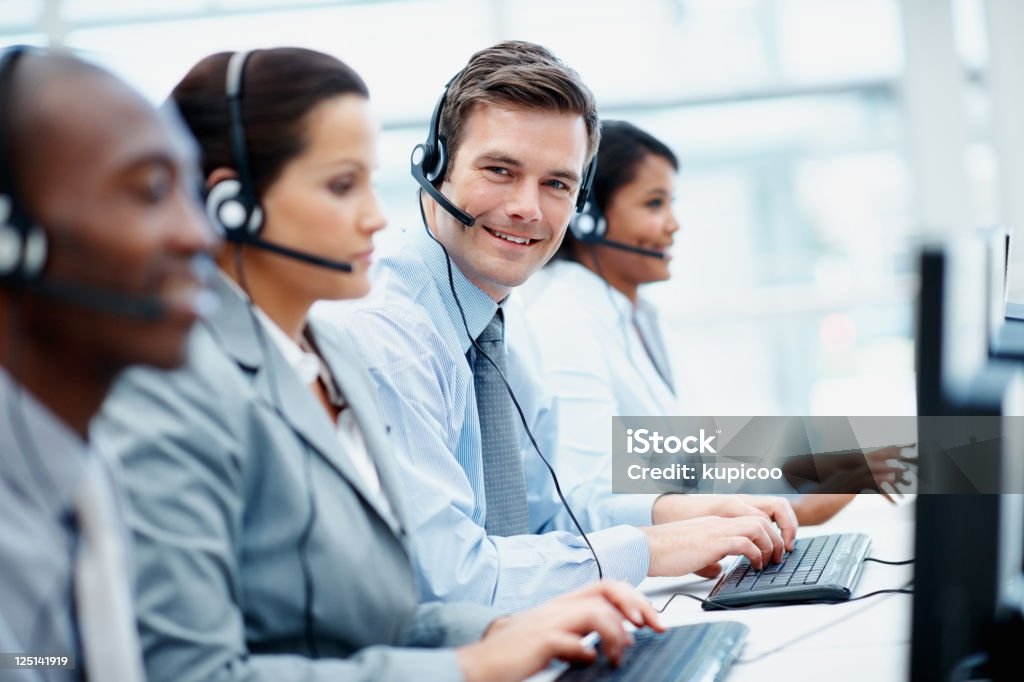 Customer support team in an office wearing headsets  Call Center Stock Photo