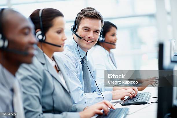 Customer Support Team In An Office Wearing Headsets Stock Photo - Download Image Now