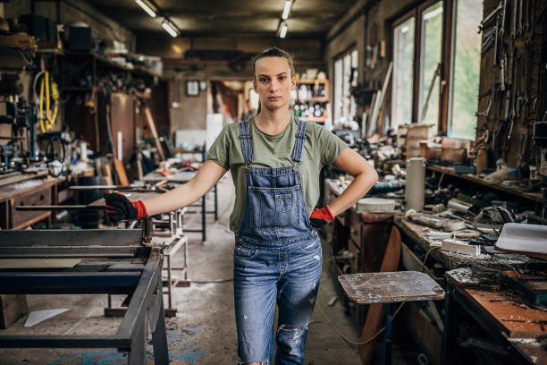 istock Young woman manual worker standing in workshop 1251419282