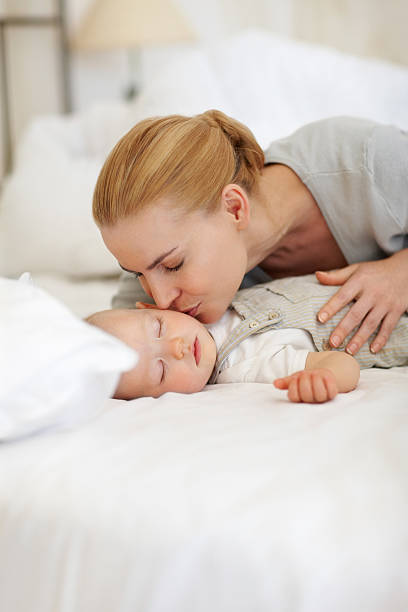 istock Mother kissing sleeping baby 125141935