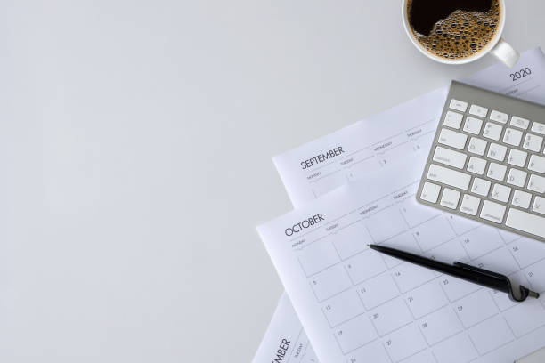istock top view of office desk workspace with coffee cup, keyboard and work schedule on white table background. flat lay 1251422298