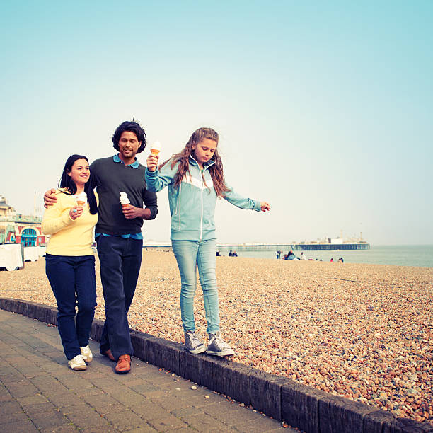 Family Eating Ice Cream at the Beach  teenager couple child blond hair stock pictures, royalty-free photos & images