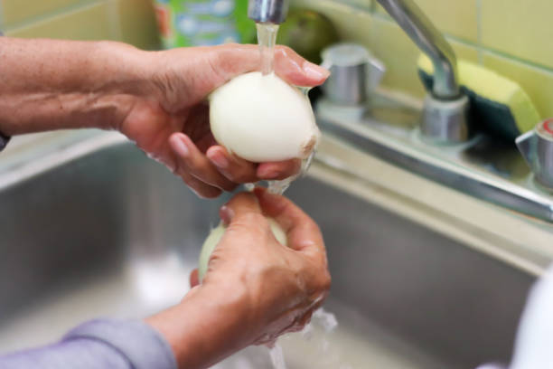 istock Washing onions on the sink 1251423042