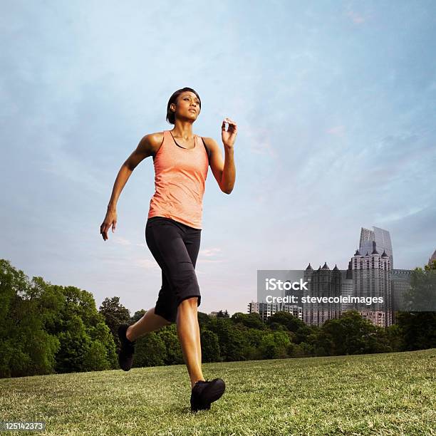 Woman Running In Piedmont Park On Grass Field Stock Photo - Download Image Now - African-American Ethnicity, Marathon, 25-29 Years