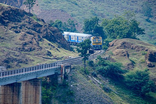 Pune, India - November 03 2019: Passenger train crossing a viaduct at Shindawane near Pune India.