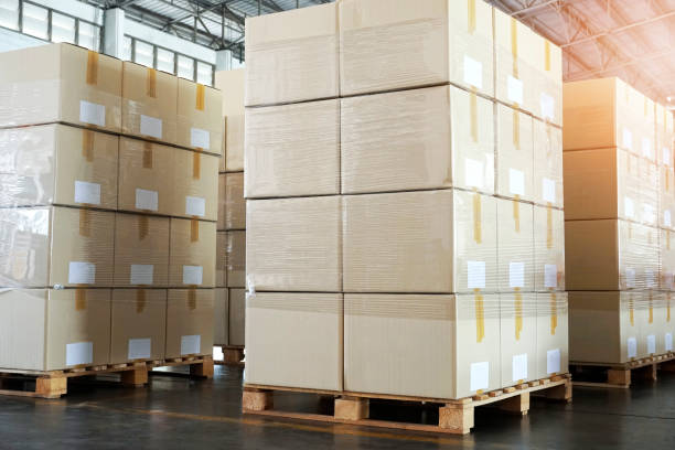 istock Stack of cardboard boxes on wooden pallets. Shipment boxes, packaging. 1251424898