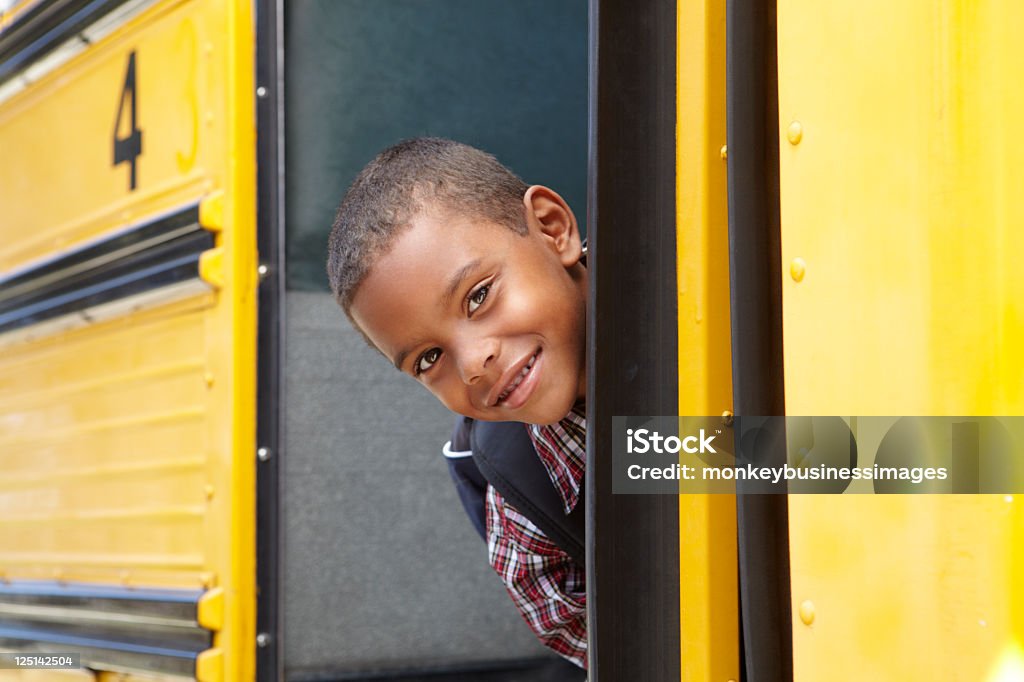 Elementary School Pupil Boarding Bus Elementary School Pupil Boarding Bus Looking Around Door School Bus Stock Photo