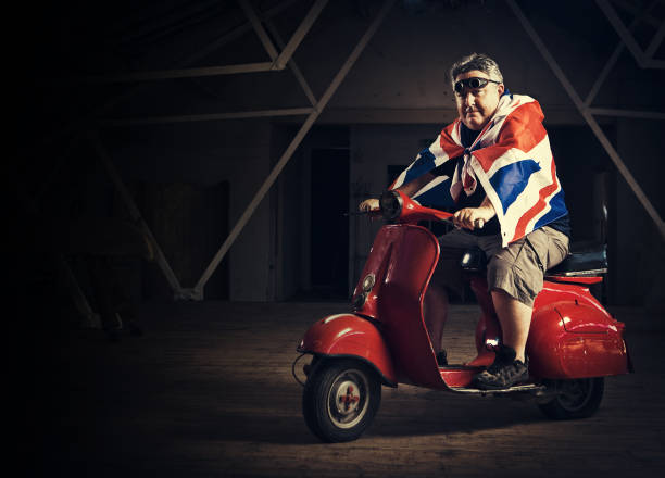 istock mature man ridding a vespa 125142547