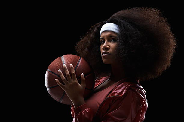 Female basketball player on black background