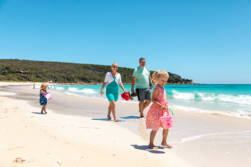 A shot of a caucasian family visiting the beach on a sunny day in Perth, Australia.