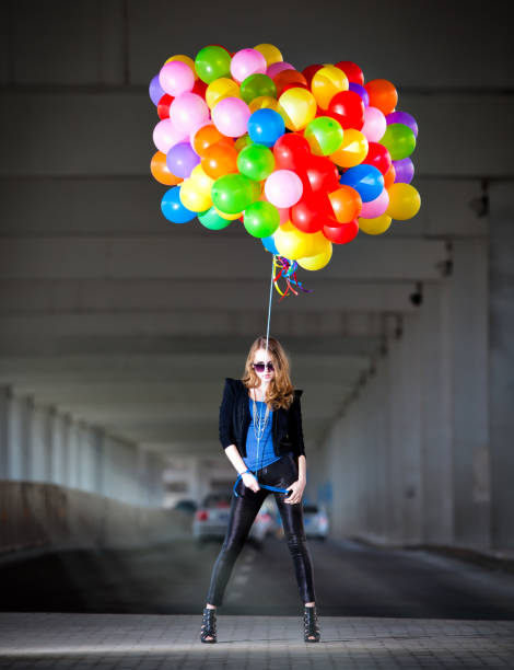 istock Woman holding many balloons 125143049