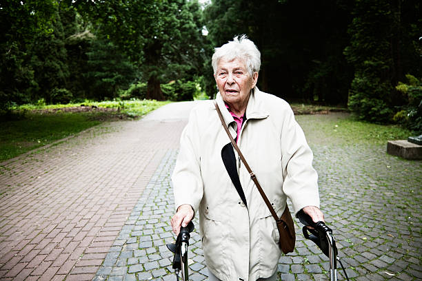 istock senior woman with walker in park 125143131