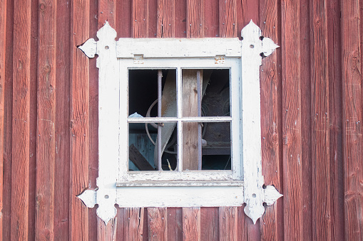 Close up of an old wooden window in a red Swedish farmhouse, rural scene
