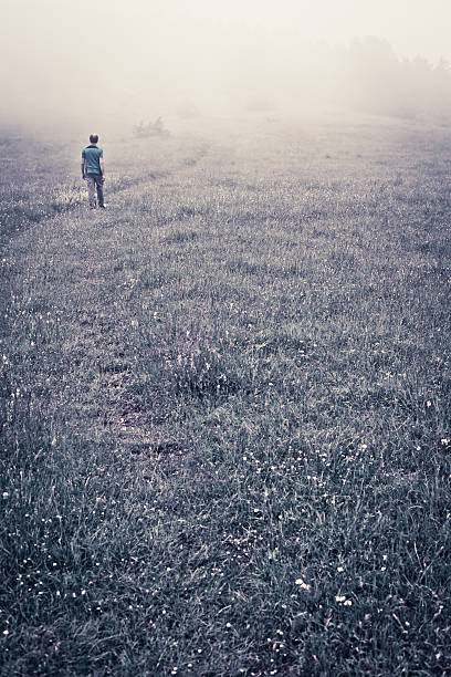man trekking in the mountain with fog in winter season