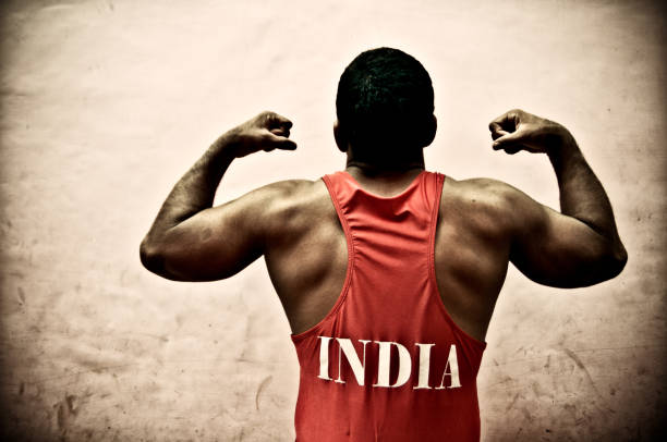 indian wrestler - bicep human arm macho flexing muscles stock-fotos und bilder