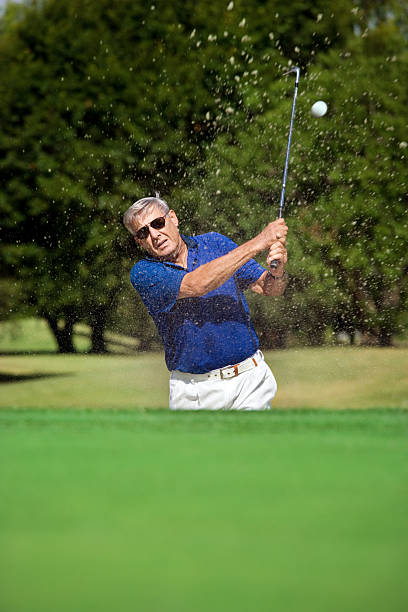 istock Senior Golfer In Sandtrap On Course 125144102