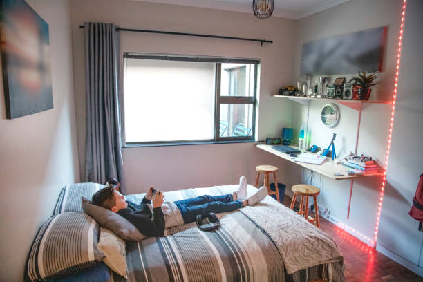 istock A Nine-year-old boy using a mobile phone on his bed at home. 1251441494