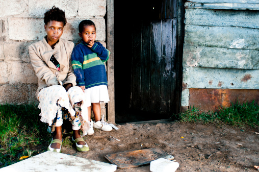 Xhosa mother with son sitting outside their home, Mthatha, Transkei, South Africa.