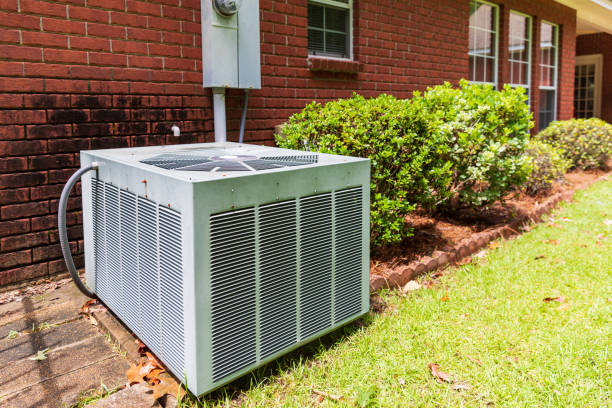 istock Older style air conditioner system next to home, brick and bushes with clean yard. 1251443493
