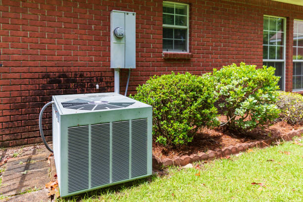 istock Older style air conditioner system next to home, brick and bushes with clean yard. 1251443550
