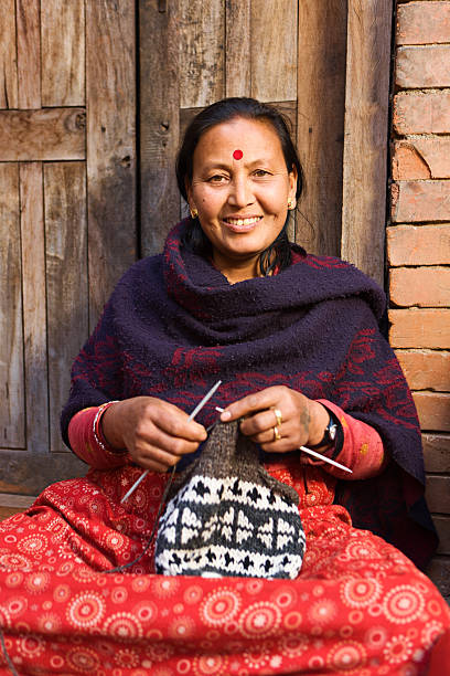 Nepali woman  kniting wool hat. Bhaktapur.  patan durbar square stock pictures, royalty-free photos & images