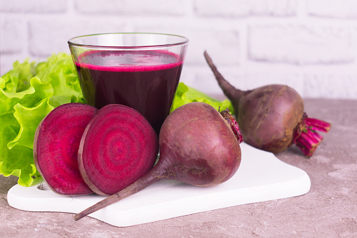 Fresh healthy beet juice in a glass  on  a white background.