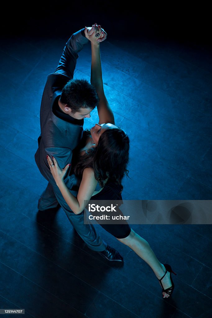 Two people dancing a passionate tango Young couple dancing tango in the studio Ballroom Dancing Stock Photo