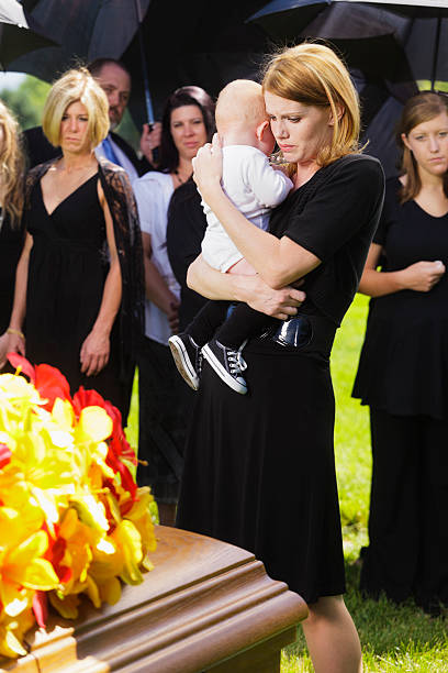 istock Mother and Baby at a Funeral 125144782