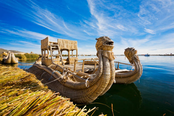 Reed Boat In Lake Titicaca, Peru Reed Boat In Puno, Peru On Lake Titicaca The World's Highest Navigable Lake reed grass family photos stock pictures, royalty-free photos & images