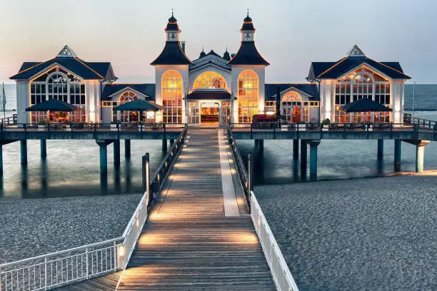 Pier with restaurant in Sellin at dusk, Baltic Sea, R