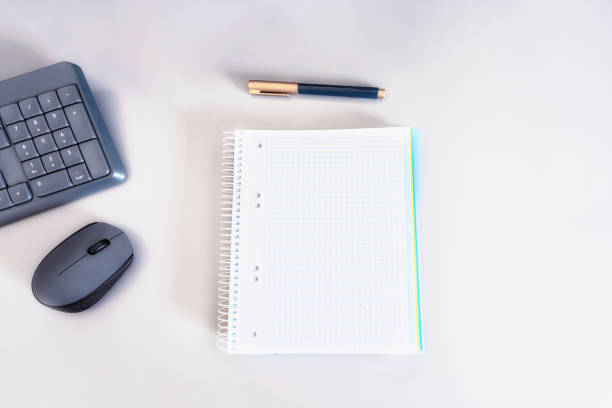istock Opent  notebook with pen, computer mouse and keyboard on the table for education on line or work at distance concept. 1251449698
