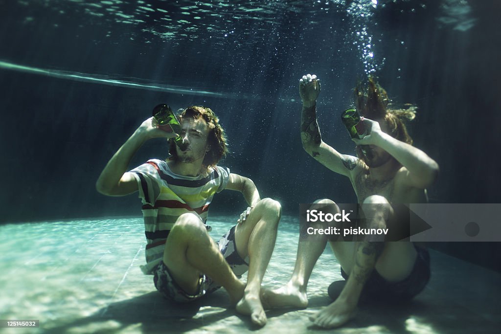 Two young men drinking beer in pool Bizarre Stock Photo Two young men drinking beer in pool Bizarre Stock Photo