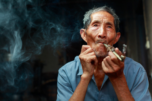 picture of one senior Chinese man smoking.