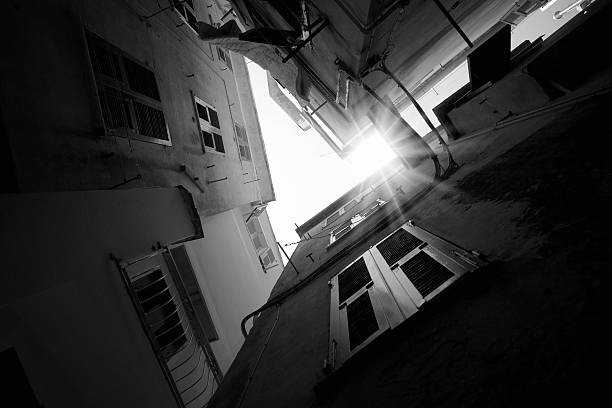 Sun in the dark Alley. Black and white. Flares.