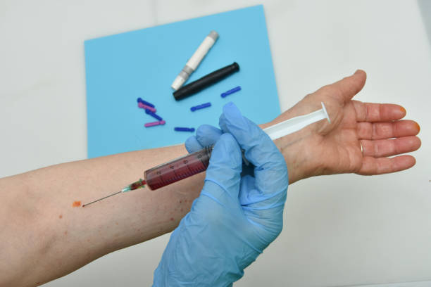 istock Laboratory assistant taking blood with syringe,Amfetamine, Speed, Crystal,Crystal meth 1251453238