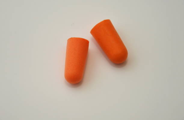 istock foam earplugs provide protection against harmful noise, orange  Protective earplugs 1251453326